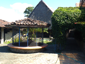 The aviary is home to two parrots. The restaurant isin the sharply peaked building beyond the aviary.
